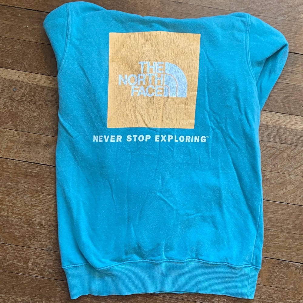 The North Face women’s Turquoise Sweatshirt with Yellow Logo Panel